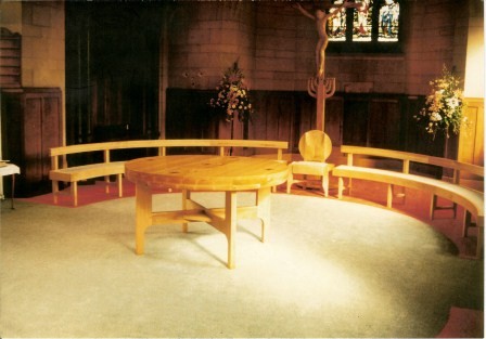 Curved benches and chair around an altar